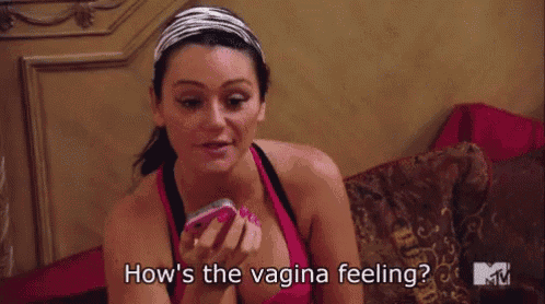 a woman is sitting on a bed holding a cell phone and says how 's the vagina feeling ?