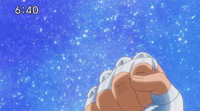 a person 's fist in the air with the time 6:40