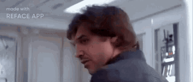 a man with a beard is standing in a room and looking over his shoulder .