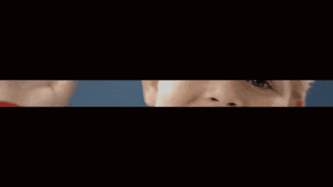 a close up of a child 's face smiling with a blue background