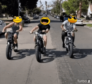 three people are riding motorcycles with smiley faces on their heads