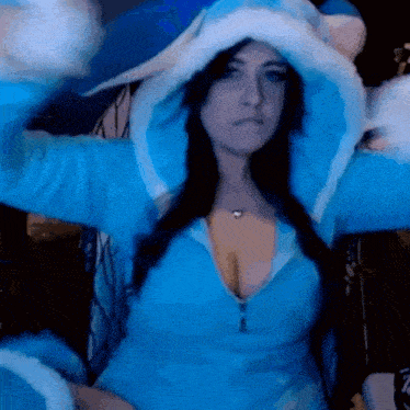 a woman in a blue sweater with a hood