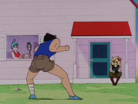 a man in a blue shirt is doing a kick in front of a house