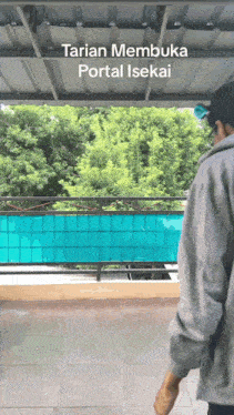 a man standing under a roof with the words " tarian membuka portal isekai " on the top