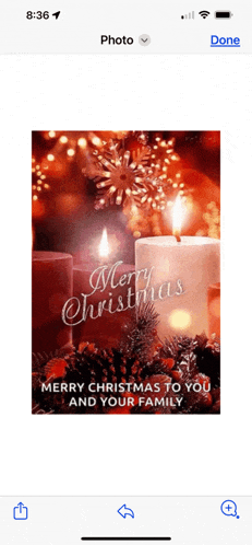 a phone screen shows a merry christmas card