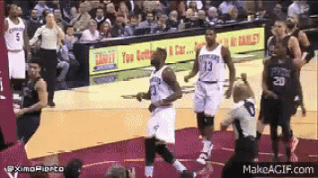 a group of basketball players are playing a game of basketball .