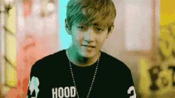 a young man is wearing a black shirt with the word hood on it .