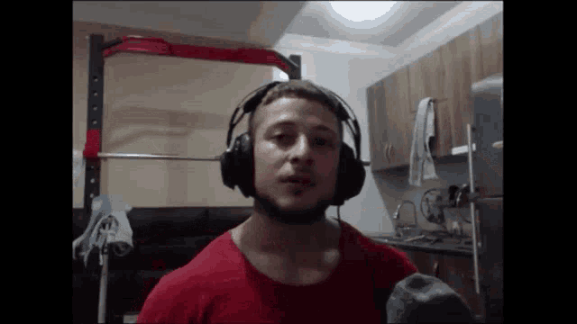 a man wearing headphones and a red shirt