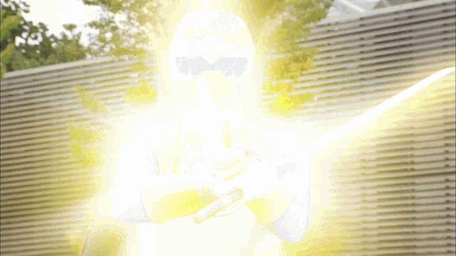 a person holding a sword with a glowing light coming out of their face