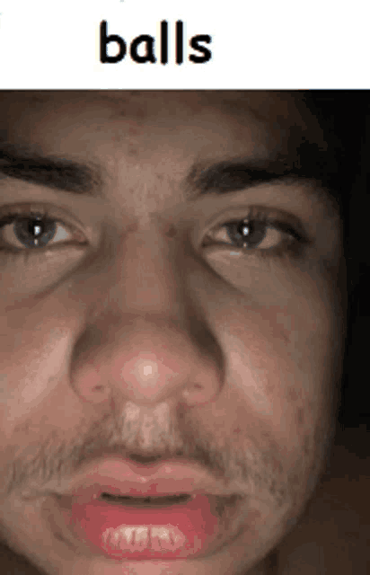 a close up of a man 's face with the word balls on the top