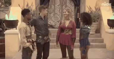 a group of people are standing next to each other in front of a building and talking .
