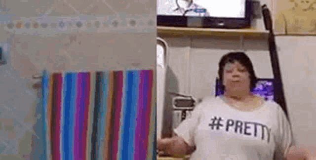 a woman wearing a t-shirt that says `` pretty '' is dancing in a bathroom .