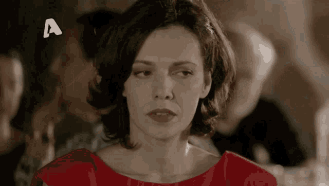 a woman in a red dress with the letter a on the bottom right