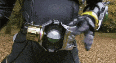 a close up of a person wearing a belt that has a green ball on it