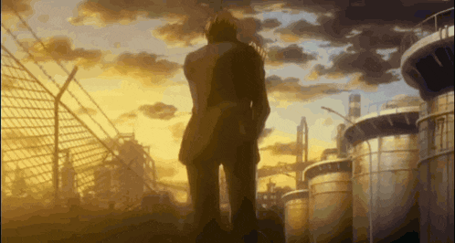 a man in a suit is standing in front of a fence looking at a sunset