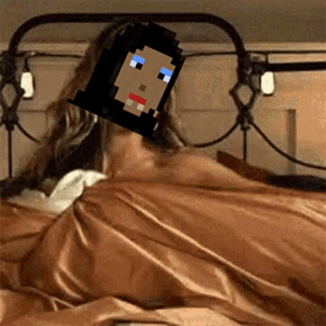 a woman is laying in bed with a pixelated face covering her face