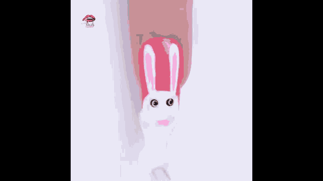 a person is applying nail polish to their nails in the shape of a bunny rabbit .