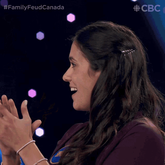 a woman applauds while wearing a bracelet with the name shyam on it