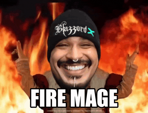a man wearing a beanie that says blazzard is smiling in front of a fire background