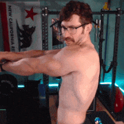 a shirtless man is lifting a barbell in front of a new california flag