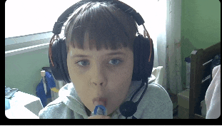 a young boy wearing headphones with a microphone on his head