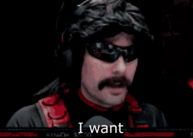 a man with a mustache is wearing headphones and sunglasses and making a funny face .