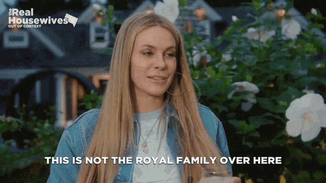 a woman holding a glass with the words this is not the royal family over here