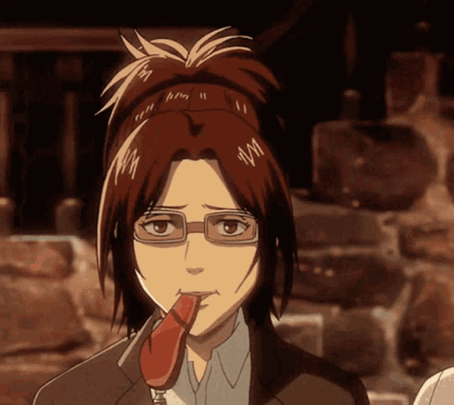 a girl with glasses is eating a red item