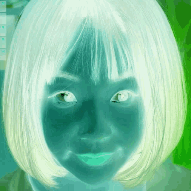 a close up of a woman 's face with a green background and a few buttons on it