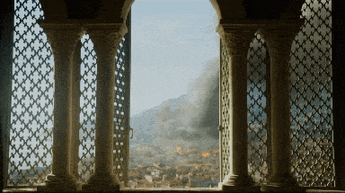 a window with columns and a view of a city with smoke coming out of it