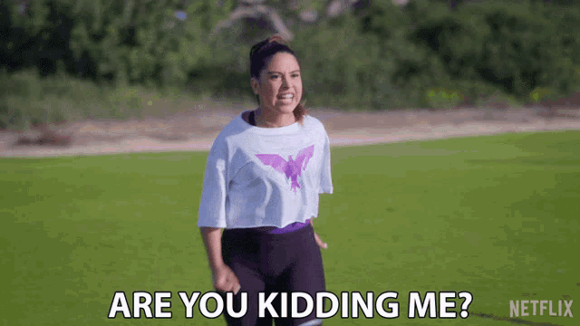 a woman running on a field with the words are you kidding me