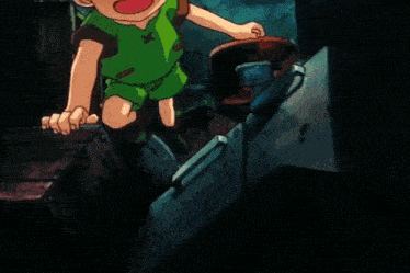 a young boy in a green shirt with a cross on it