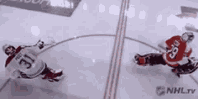 a hockey player with the number 31 on his jersey is being chased by another player