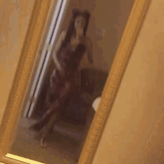 a woman is taking a selfie in a mirror
