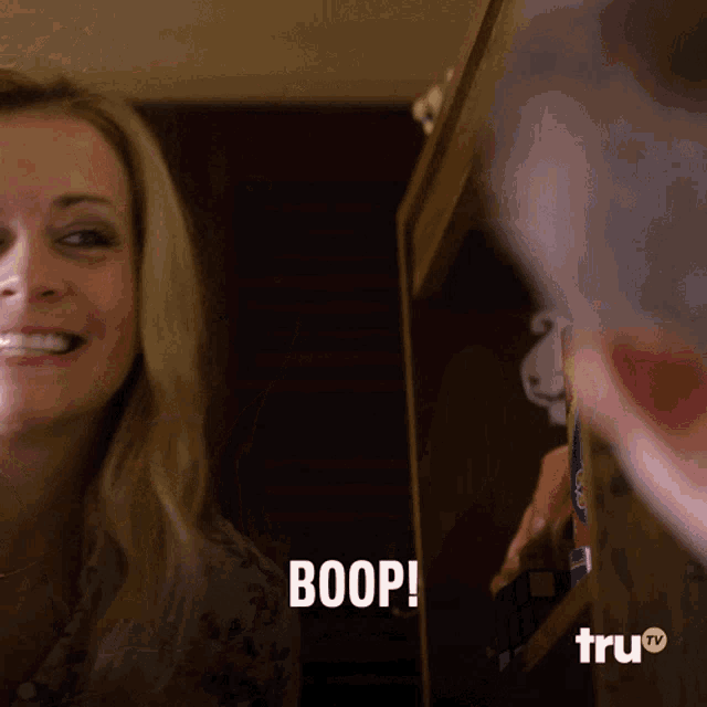 a woman is smiling and says boop in front of a tru tv logo