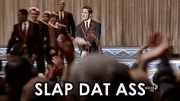 a group of people standing in front of a crowd with the words slap dat ass written on the bottom .