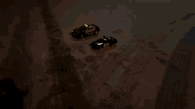 a blurred image of two cars driving down a snowy road at night