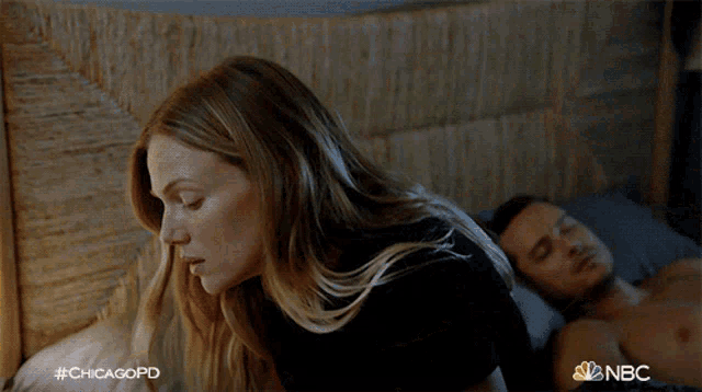 a woman standing next to a shirtless man in a bed with #chicagopd on the bottom