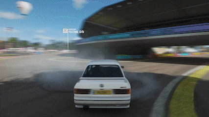 a white car driving down a road with a sign that says festival 9/10