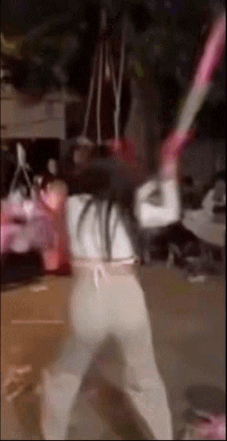 a blurry picture of a person holding a bat with the letter y on the back