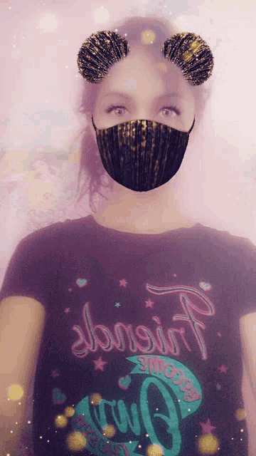 a girl wearing a mask and a t-shirt that says almost