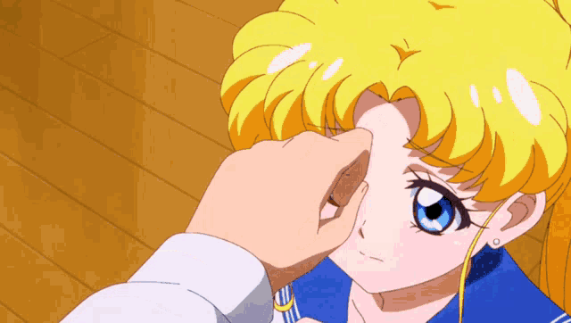 a person is touching a girl 's face with their finger