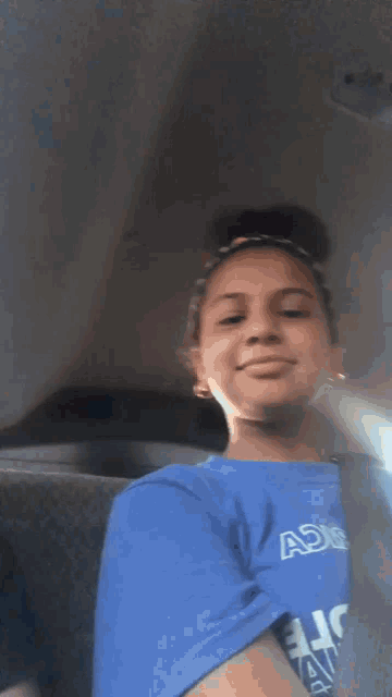 a blurry picture of a girl looking out a window .