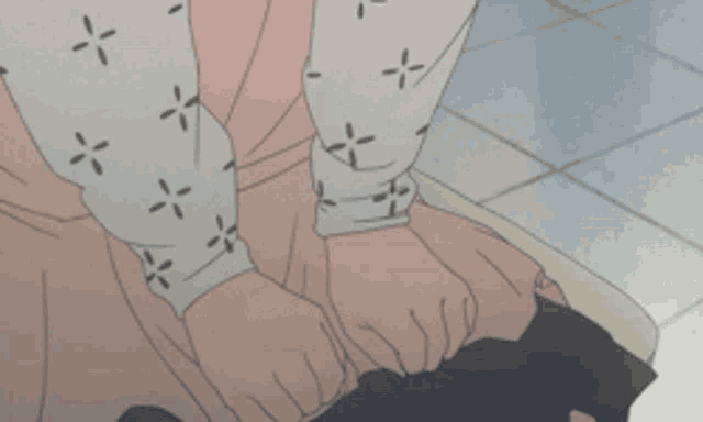 a close up of a person 's hands on a black object