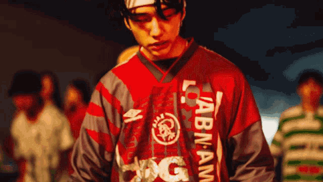 a man wearing a labnam jersey stands in front of a crowd