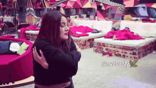 a woman is hugging another woman in a room with the words seriously on the bottom