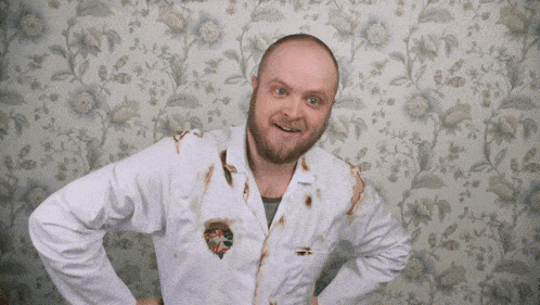 a man wearing a lab coat with a sticker on it that says ' i am a scientist '