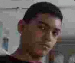 a close up of a man 's face with a blurred background and a blurry background .