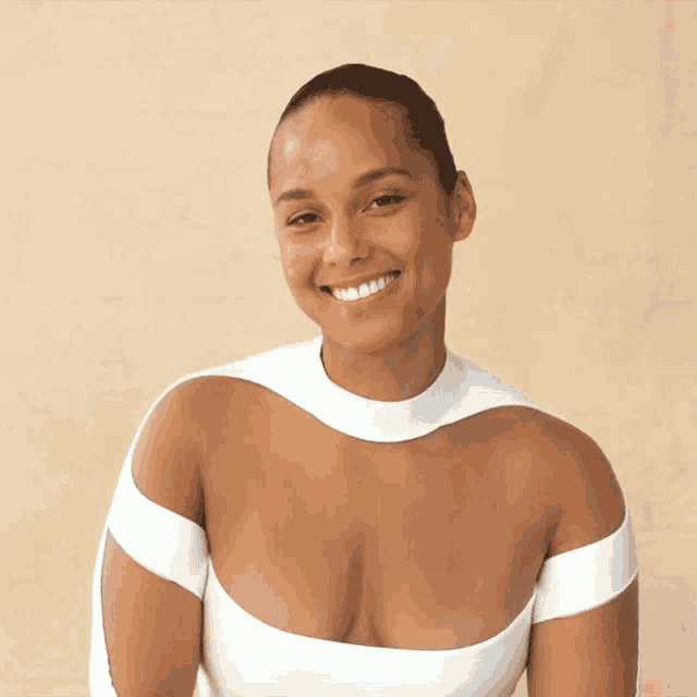 a woman in a very plunging white top smiles