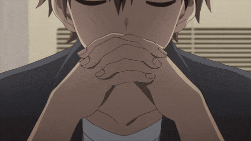 a man with his eyes closed and his hands folded